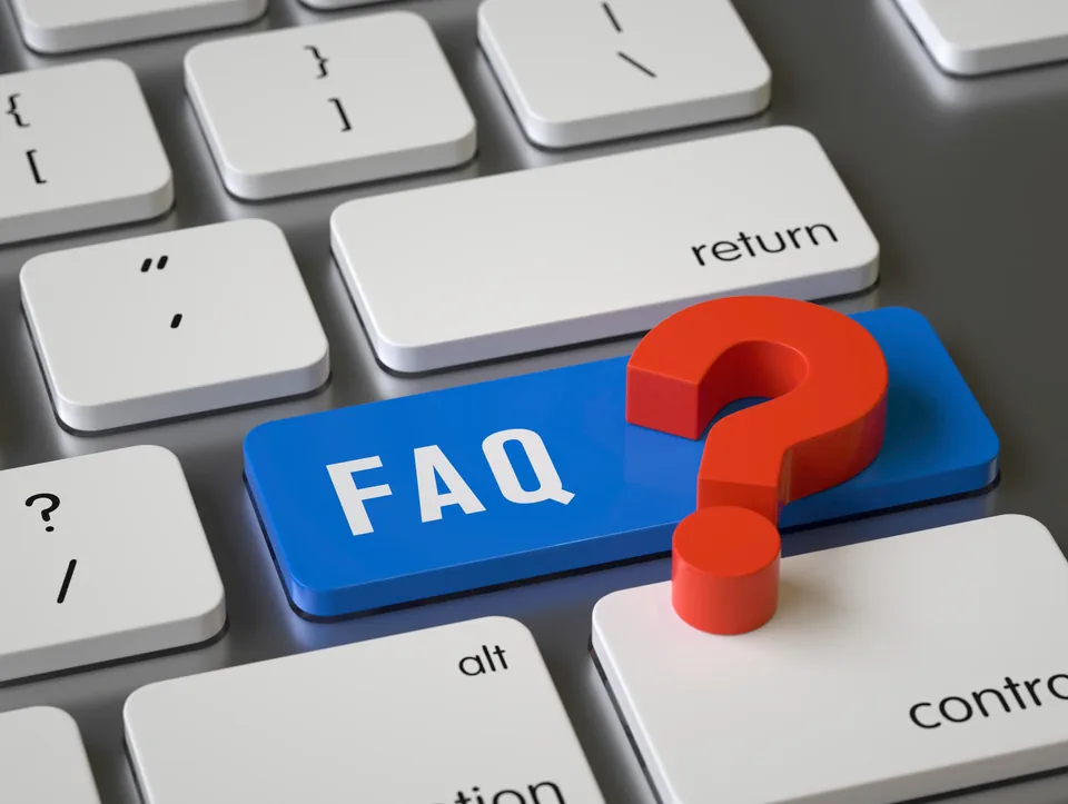 A computer keyboard with a blue key labelled FAQ beside a red question mark.